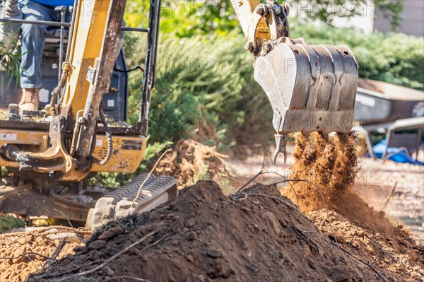 Working excavator tractor digging A trench at construction site