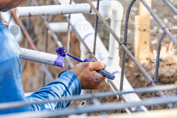 Plumber applying pipe cleaner