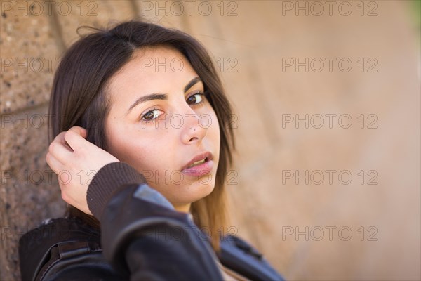 Beautiful meloncholy mixed-race young woman portrait outside