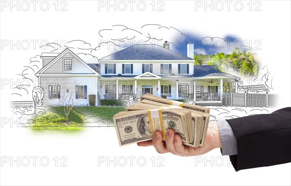 Hand holding thousands of dollars in cash over house drawing and photo area