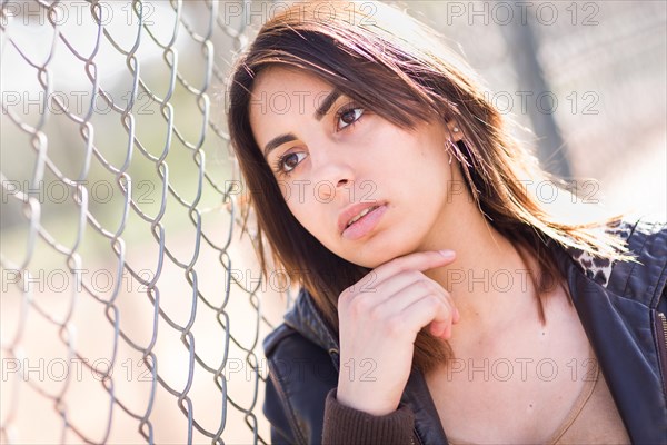 Beautiful meloncholy mixed-race young woman portrait outside