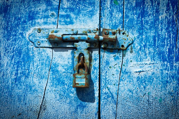 Old latch with padlock on the door