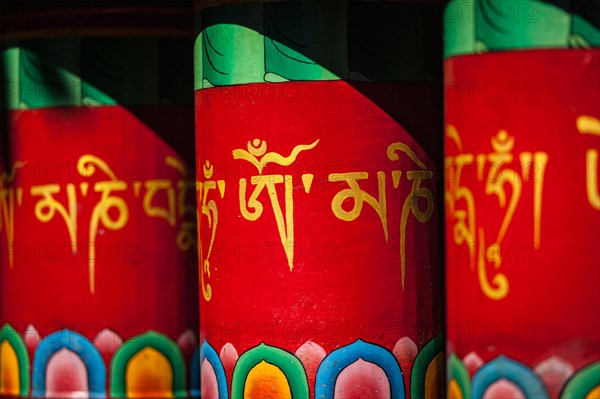 Buddhist prayer wheels with om mani padme hum