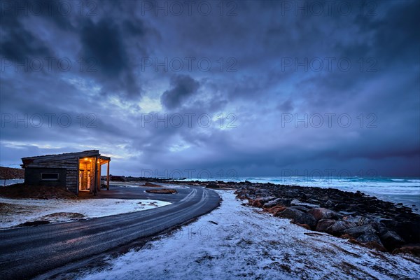 Shack on coast of Norwegian sea in fjord. Skagsanden beach