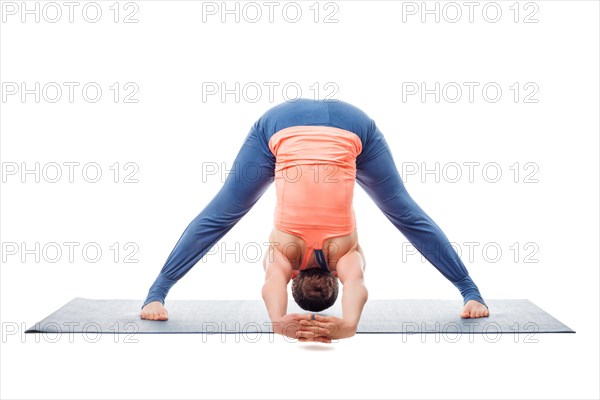 Beautiful sporty fit woman practices Ashtanga Vinyasa yoga asana Prasarita padottanasana C