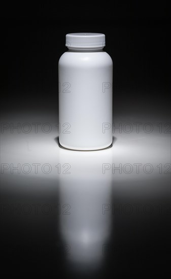 Blank white bottle ready for your text under spot light