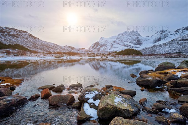 Sunset in Norwegian fjord in winter. Lofoten islands