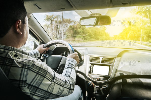 Inside view of a man driving a car