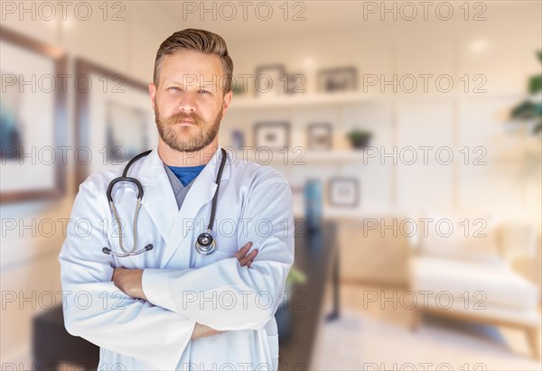 Handsome young adult male doctor with beard inside office