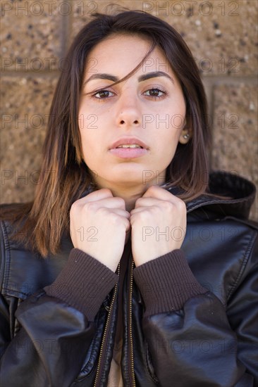 Beautiful meloncholy mixed-race young woman portrait outside