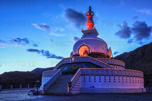 Shanti stupa illuminated in the evening twilight. Leh