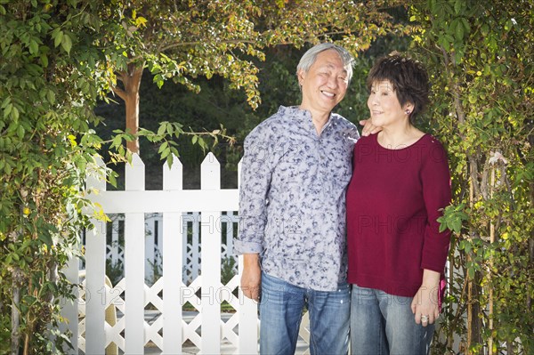 Attractive happy chinese couple enjoying their house outside