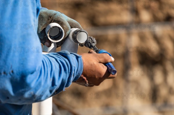 Plumber applying pipe cleaner