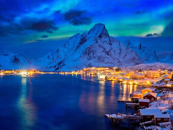 Reine village illuminated at night with Aurora Borealis. Lofoten islands