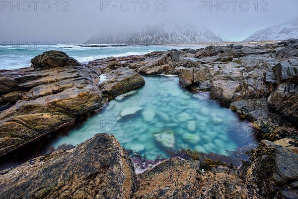 Rocky coast of fjord of Norwegian sea in winter. Lofoten islands