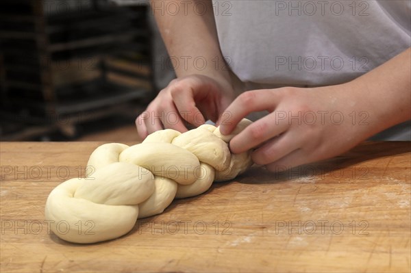 Bakers plaiting butter plait