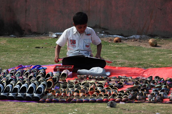 Shoe seller in a meadow