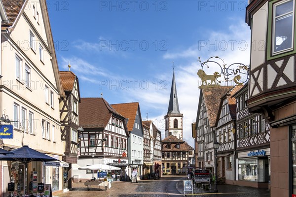 View of the pedestrian zone with church in the old town of Lohr am Main with half-timbered houses