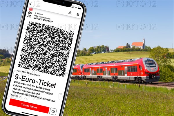 9-euro ticket on the mobile phone with regional train Photo montage in Aitrang