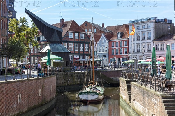 Historic merchant and warehouse houses at the Hanseatic harbour with the sailing ship Willi