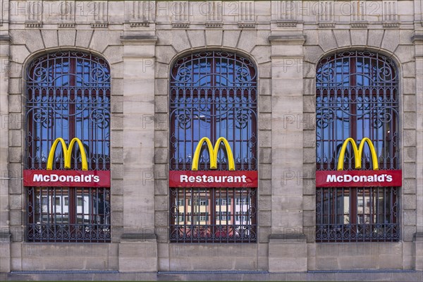 Mc Donald logos on the windows of a historic post office building