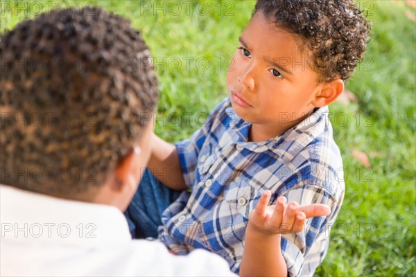 Happy african american father and mixed-race son playing at the park