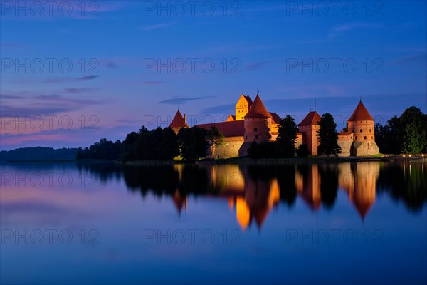 Night view of Trakai Island Castle in lake Galve illuminated in the evening