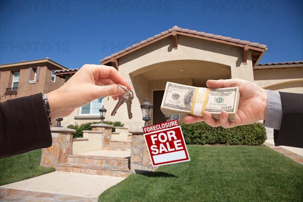 Handing over cash for house keys in front of house and foreclosure sign