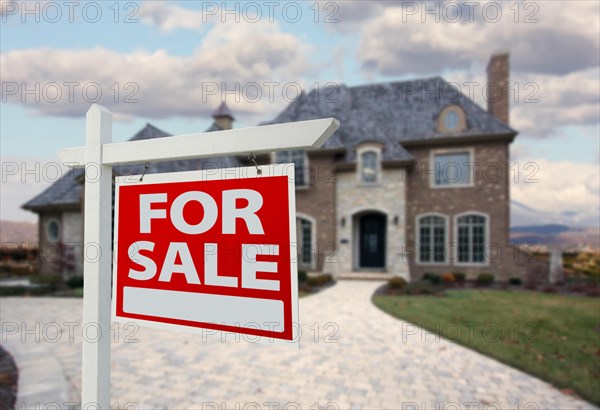 Home for sale sign in front of new house