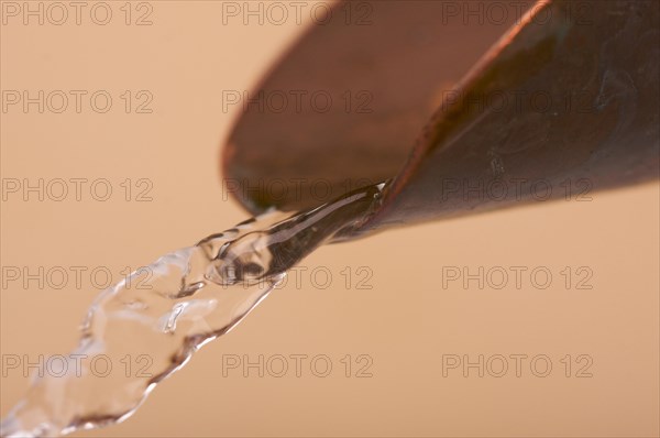 Custom copper faucet and water close-up