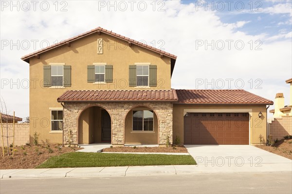 A newly constructed modern home facade and yard