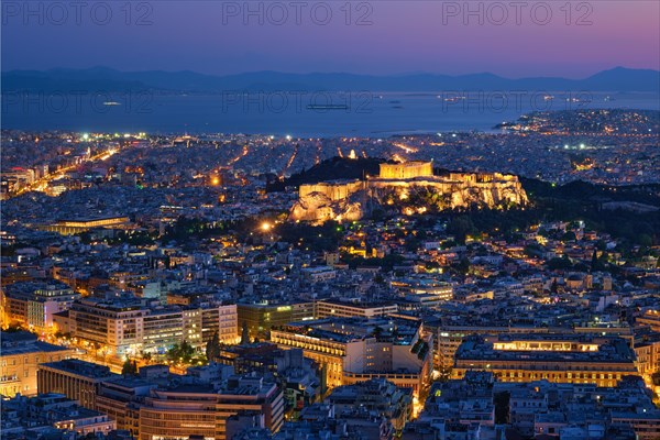 Parthenon Temple on hill is the antique tourist landmark at the Acropolis of Athens and ancient European civilization architecture on Aegean sea coast. Dusk view from Mount Lycabettus