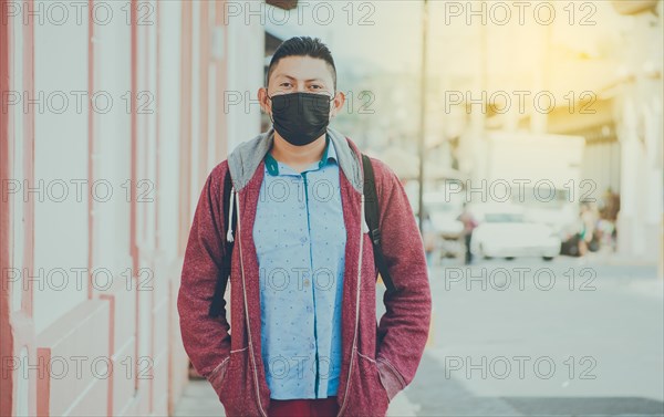 Portrait of a man in the street with a mask