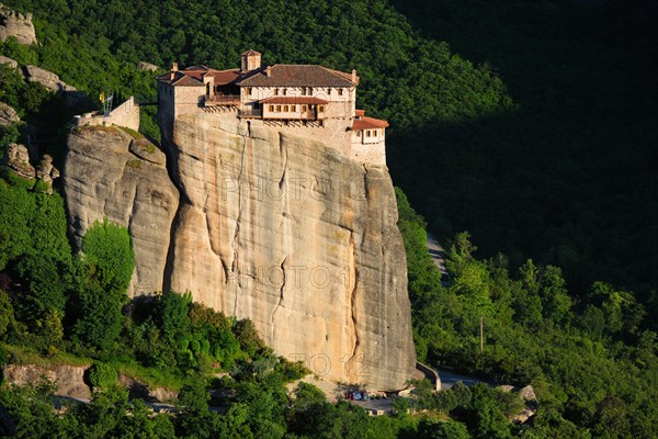 Monastery of Rousanou perched on a cliff in famous greek tourist destination Meteora in Greece on sunset with scenic landscape