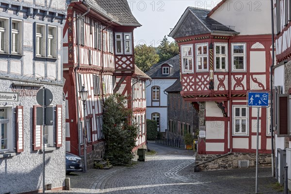 Medieval half-timbered houses with bay windows at the corner of the house