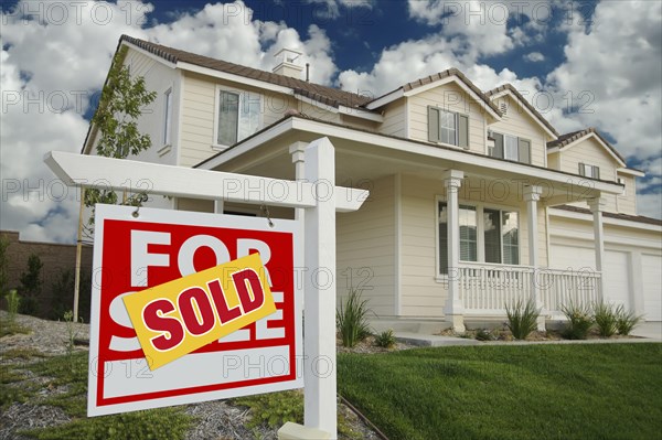 Sold home for sale sign in front of new house