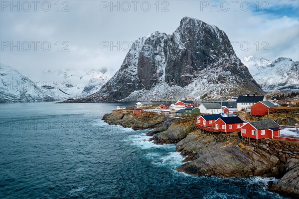 Hamnoy fishing village with red rorbu houses in Norwegian fjord in winter. Lofoten Islands