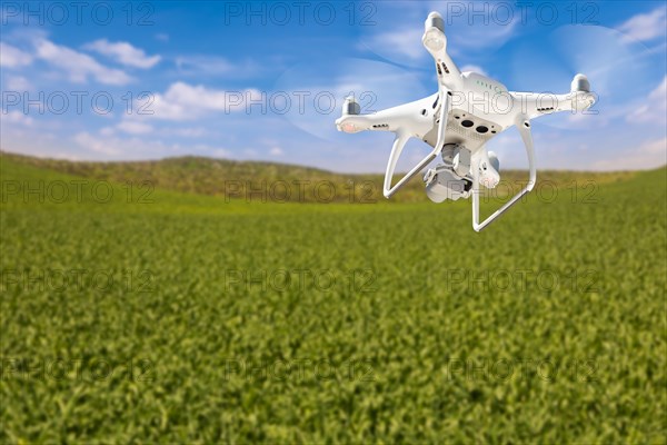 Drone unmanned aircraft flying and gathering data over country farmland