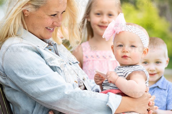 Young caucasian mother and children at the park