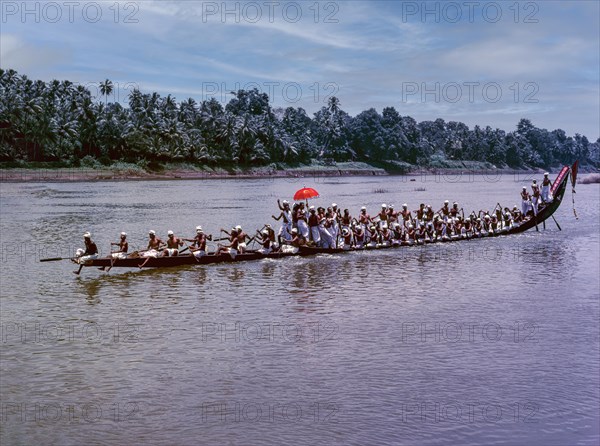 The colourful umbrellas taken in the boats by men in their traditional dress during Aranmula boat race
