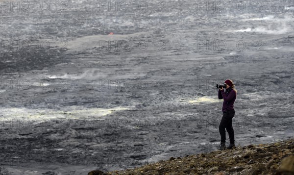 Photographer taking pictures with camera