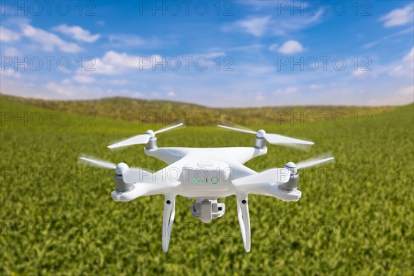 Drone unmanned aircraft flying and gathering data over country farmland