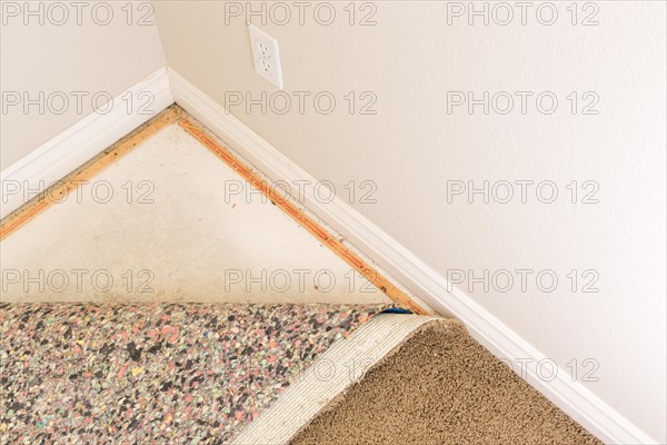 Pulled back carpet and underlay in room of house