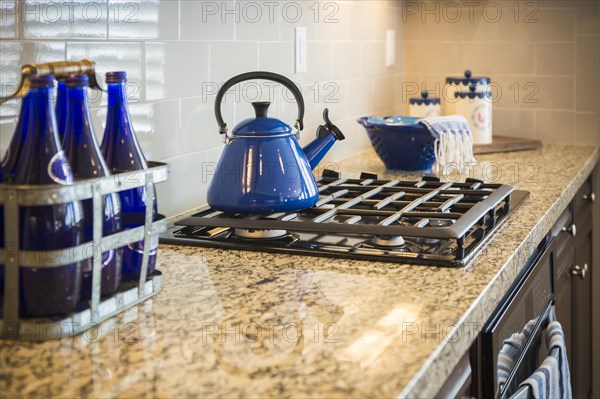 Beautiful marble kitchen counter and stove with cobalt blue decor