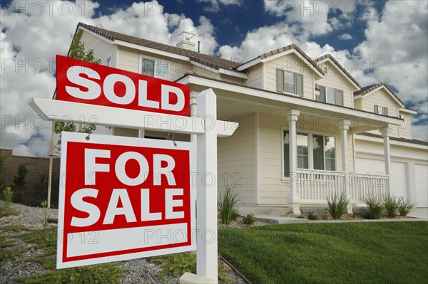 Sold home for sale sign in front of beautiful new home