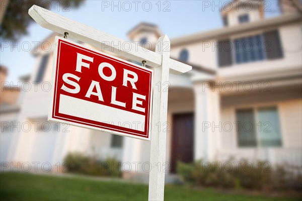 Home for sale real estate sign in front of new house