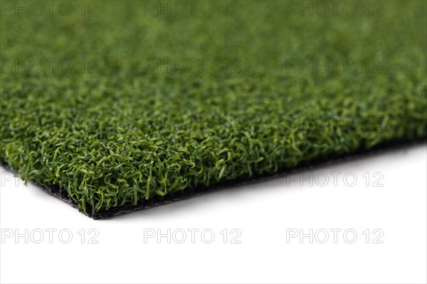 Section of artificial turf grass on white background