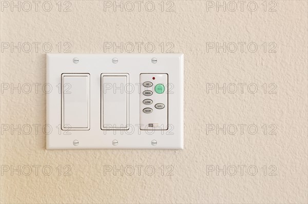 Light switches and fan control on wall of home