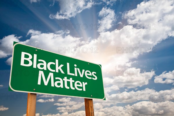 Black lives matter green road sign with dramatic clouds and sky