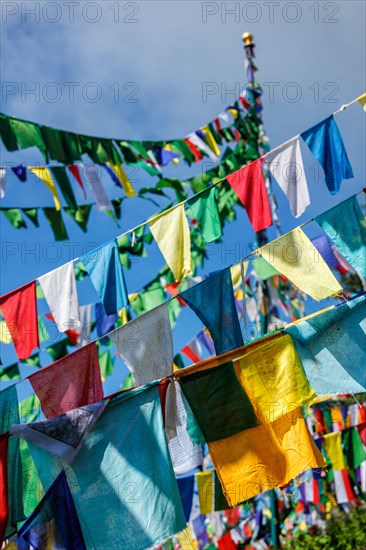 Buddhist prayer flags lungta with Om Mani Padme Hum Buddhist mantra prayer meaning Praise to the Jewel in the Lotus on kora around Tsuglagkhang complex